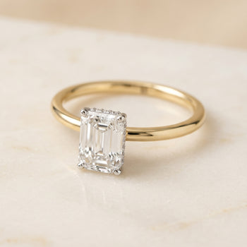 The Eartha Upper Hidden Halo Solitaire Emerald Cut Engagement Ring Setting in 18K Yellow Gold