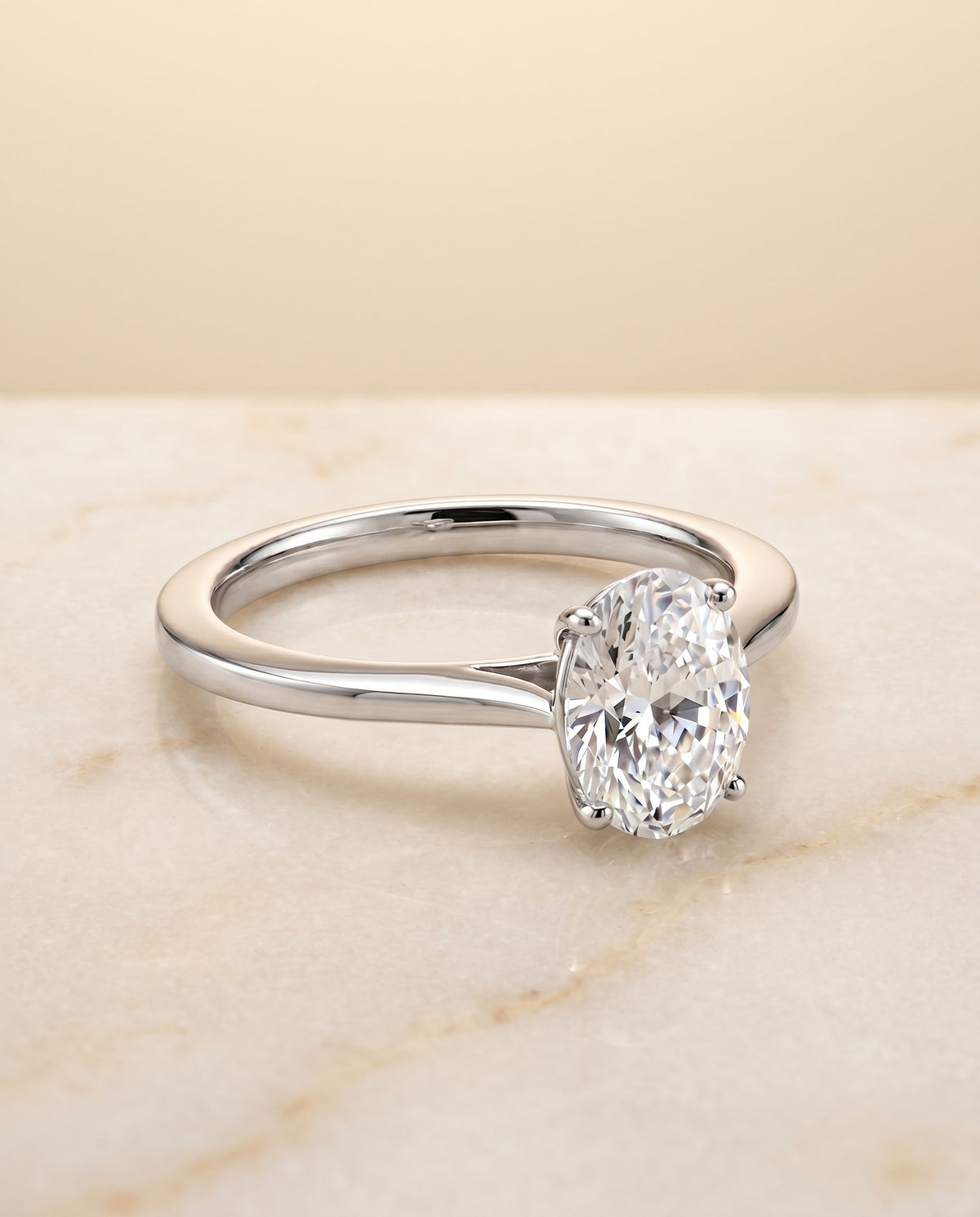 Elena Select Solitaire Oval Lab Diamond Engagement Ring in Platinum, shown on hand, angled | RockHer