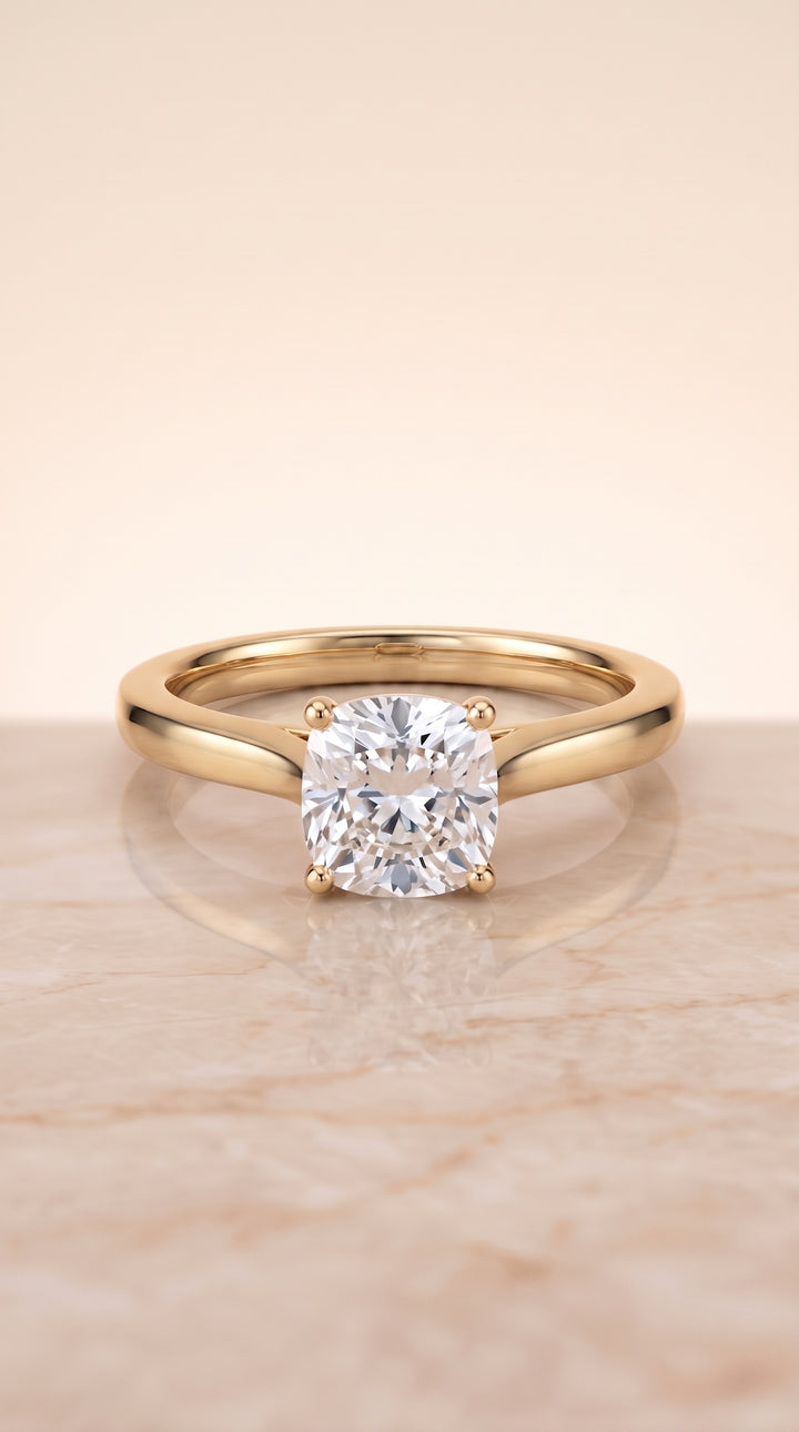 The Elena Timeless Graduated Beveled Shank Solitaire Cushion Cut Engagement Ring Setting in 18K Yellow Gold