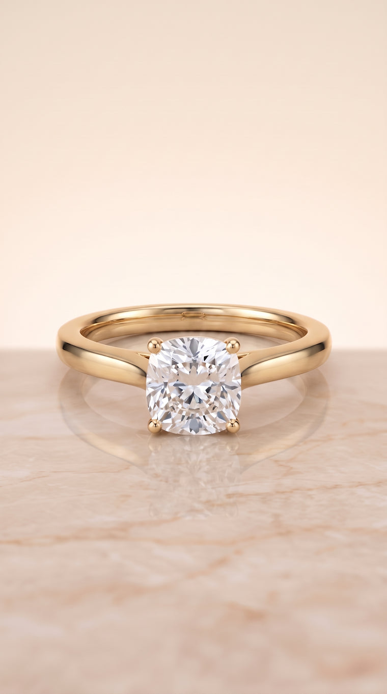 The Elena Timeless Graduated Beveled Shank Solitaire Cushion Cut Engagement Ring Setting in 18K Yellow Gold