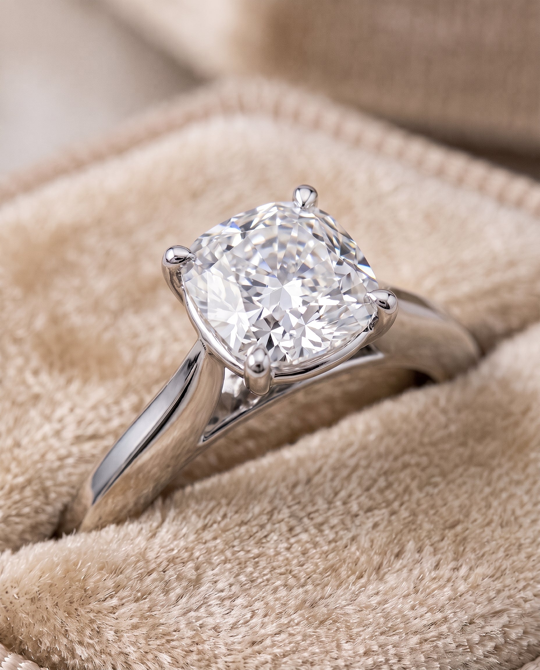 The Elena Timeless Graduated Beveled Shank Solitaire Cushion Cut Engagement Ring Setting in 18K White Gold