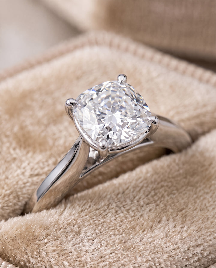The Elena Timeless Graduated Beveled Shank Solitaire Cushion Cut Engagement Ring Setting in Platinum