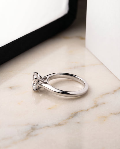 The Elena Timeless Graduated Beveled Shank Solitaire Cushion Cut Engagement Ring Setting in Platinum