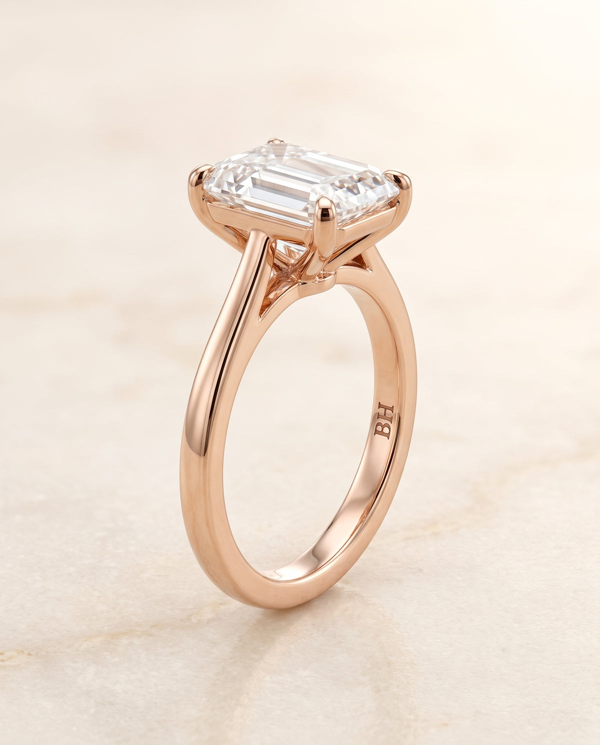 The Elena Timeless Graduated Beveled Shank Solitaire Emerald Cut Engagement Ring Setting in 14K Rose Gold