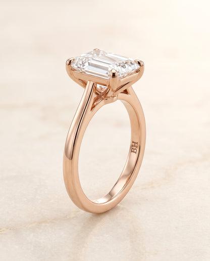 The Elena Timeless Graduated Beveled Shank Solitaire Emerald Cut Engagement Ring Setting in 14K Rose Gold