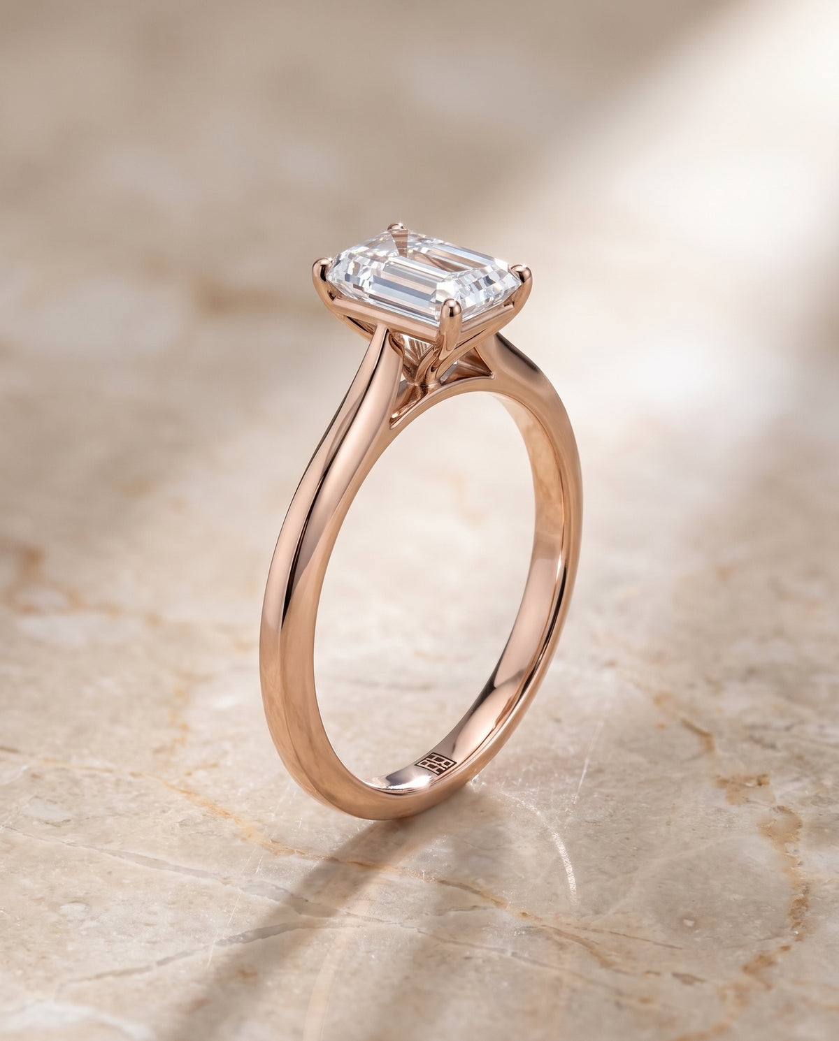 The Elena Timeless Graduated Beveled Shank Solitaire Emerald Cut Engagement Ring Setting in 14K Rose Gold