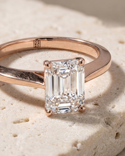 The Elena Timeless Graduated Beveled Shank Solitaire Emerald Cut Engagement Ring Setting in 14K Rose Gold