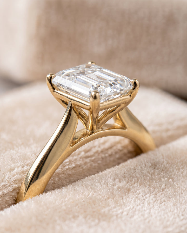 The Elena Timeless Graduated Beveled Shank Solitaire Emerald Cut Engagement Ring Setting in 18K Yellow Gold