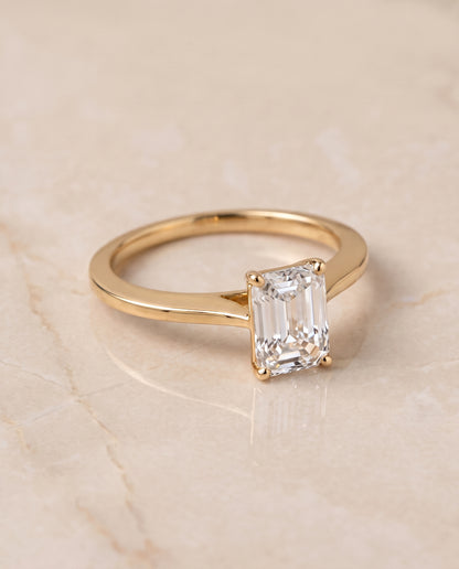 The Elena Timeless Graduated Beveled Shank Solitaire Emerald Cut Engagement Ring Setting in 18K Yellow Gold