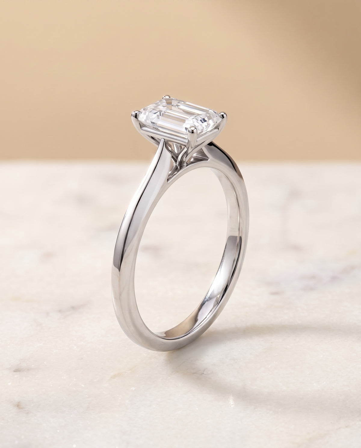 The Elena Timeless Graduated Beveled Shank Solitaire Emerald Cut Engagement Ring Setting in Platinum