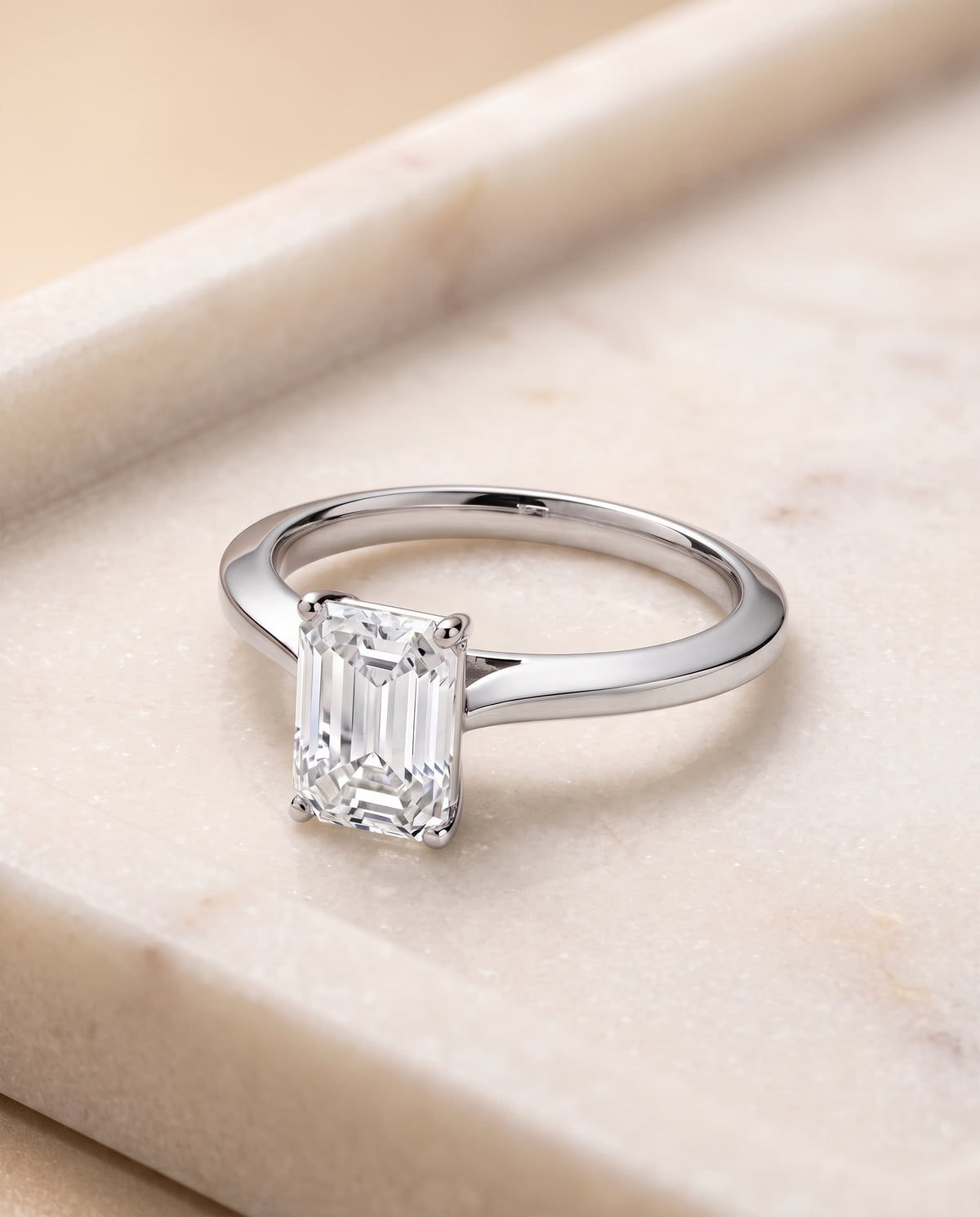 The Elena Timeless Graduated Beveled Shank Solitaire Emerald Cut Engagement Ring Setting in Platinum