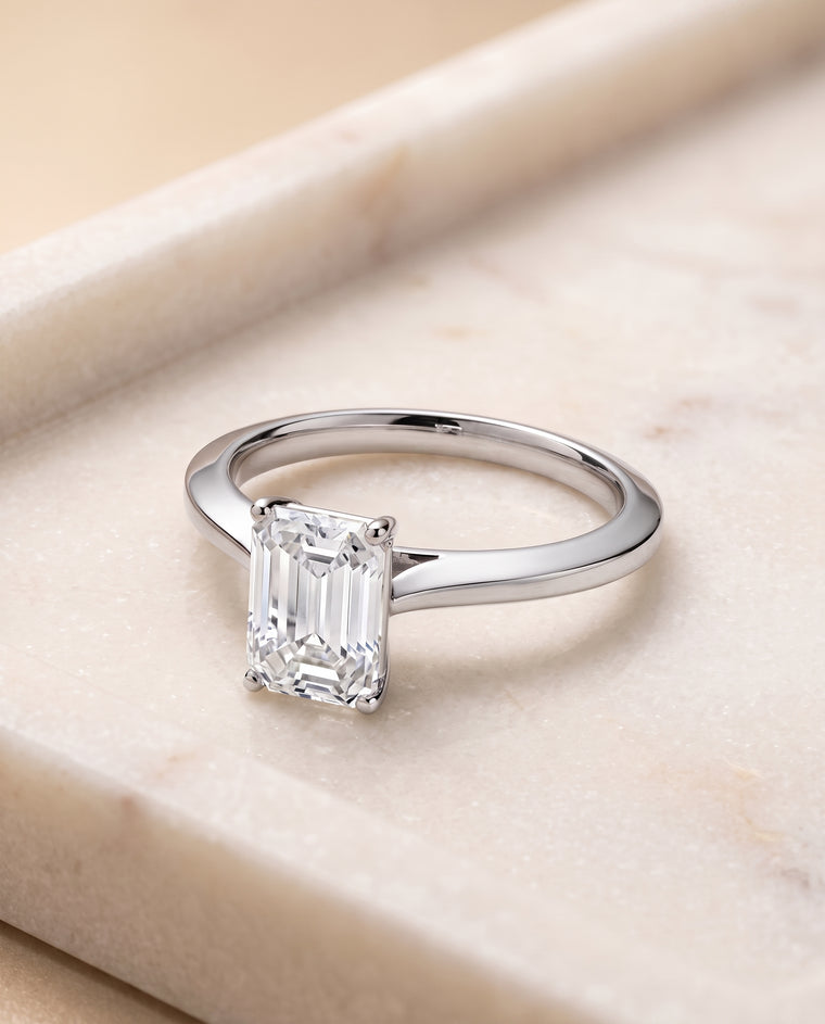 The Elena Timeless Graduated Beveled Shank Solitaire Emerald Cut Engagement Ring Setting in Platinum