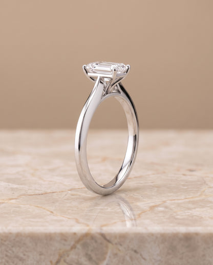The Elena Timeless Graduated Beveled Shank Solitaire Emerald Cut Engagement Ring Setting in Platinum