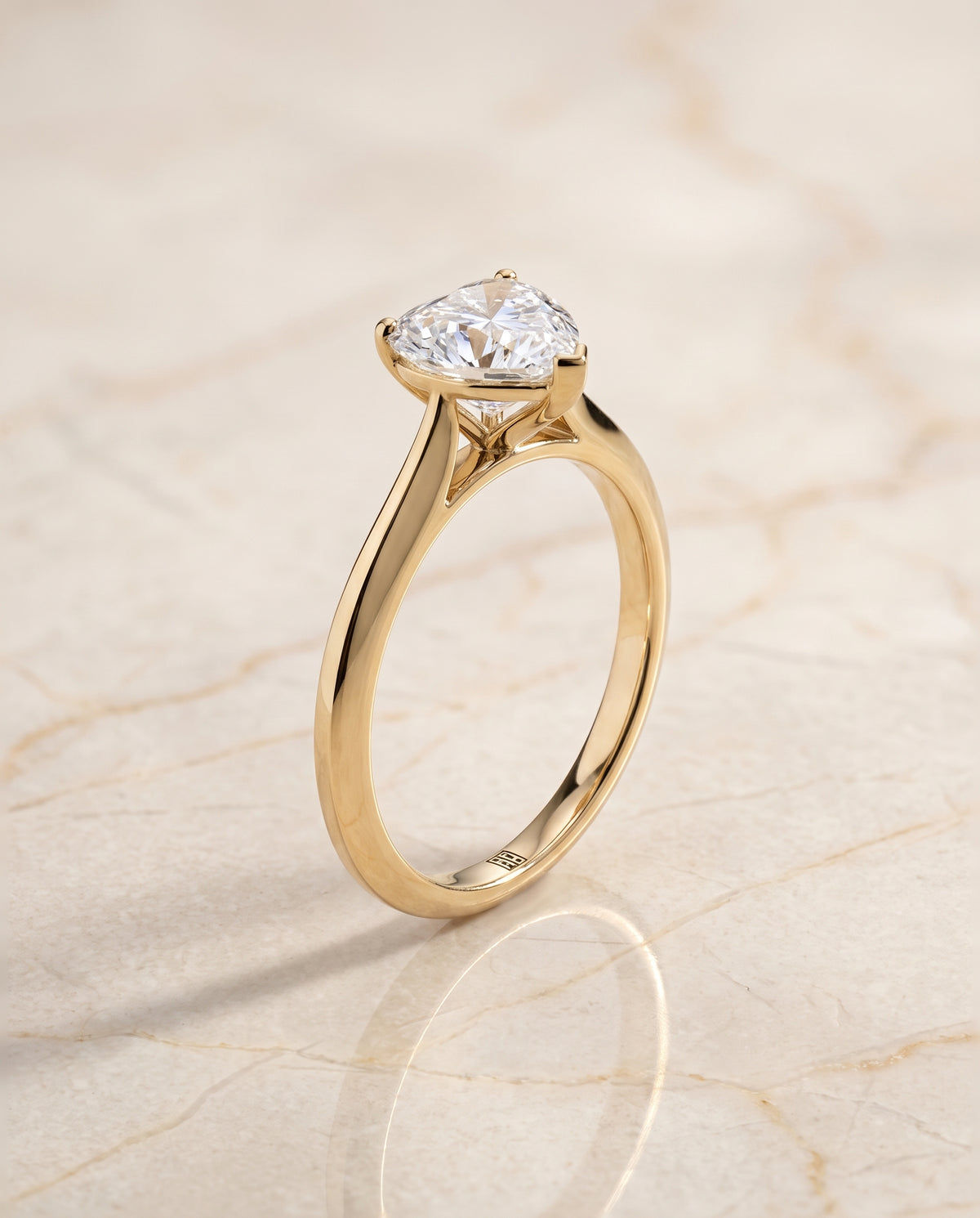 The Elena Timeless Graduated Beveled Shank Solitaire Heart Engagement Ring Setting in 18K Yellow Gold