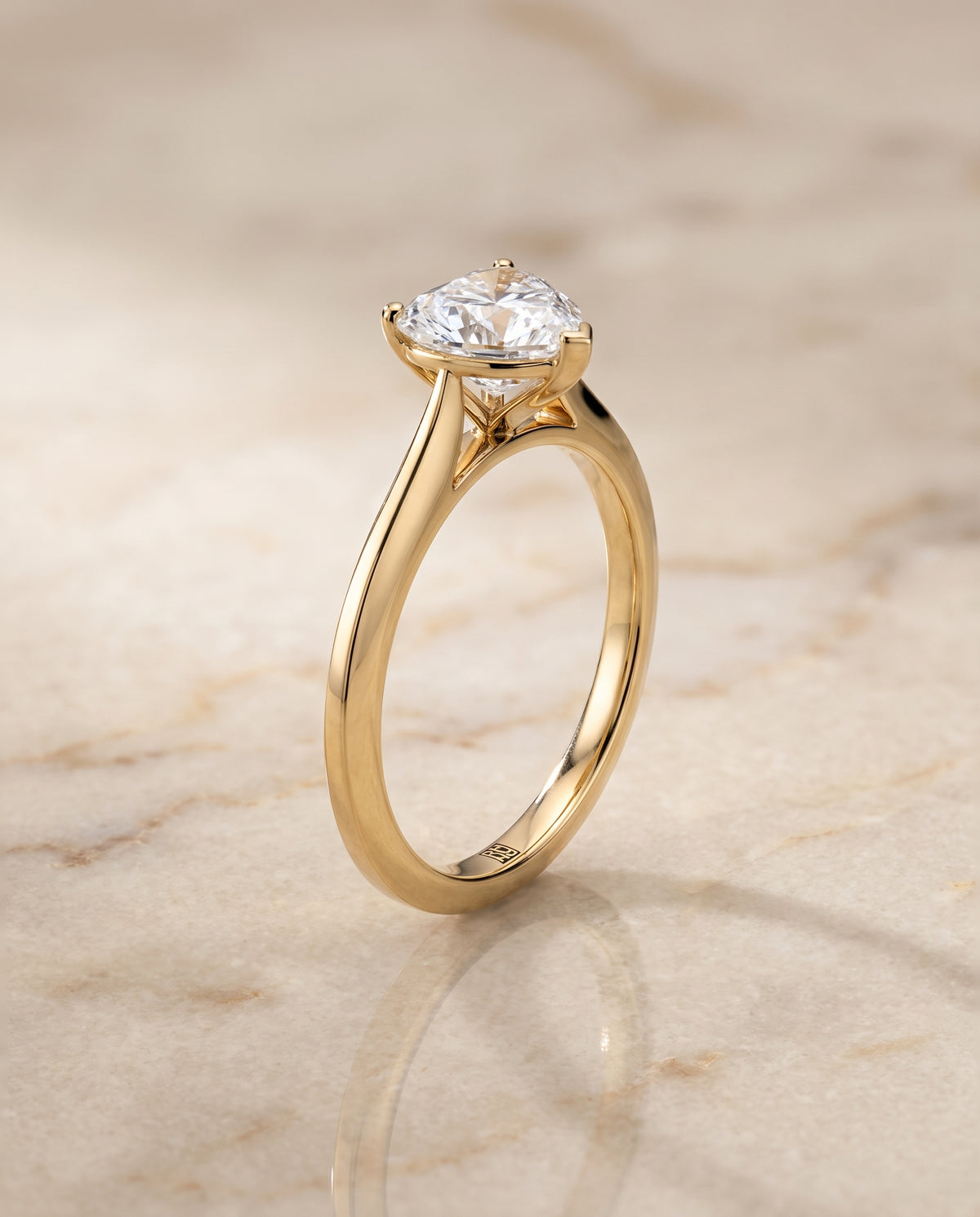 The Elena Timeless Graduated Beveled Shank Solitaire Heart Engagement Ring Setting in 18K Yellow Gold