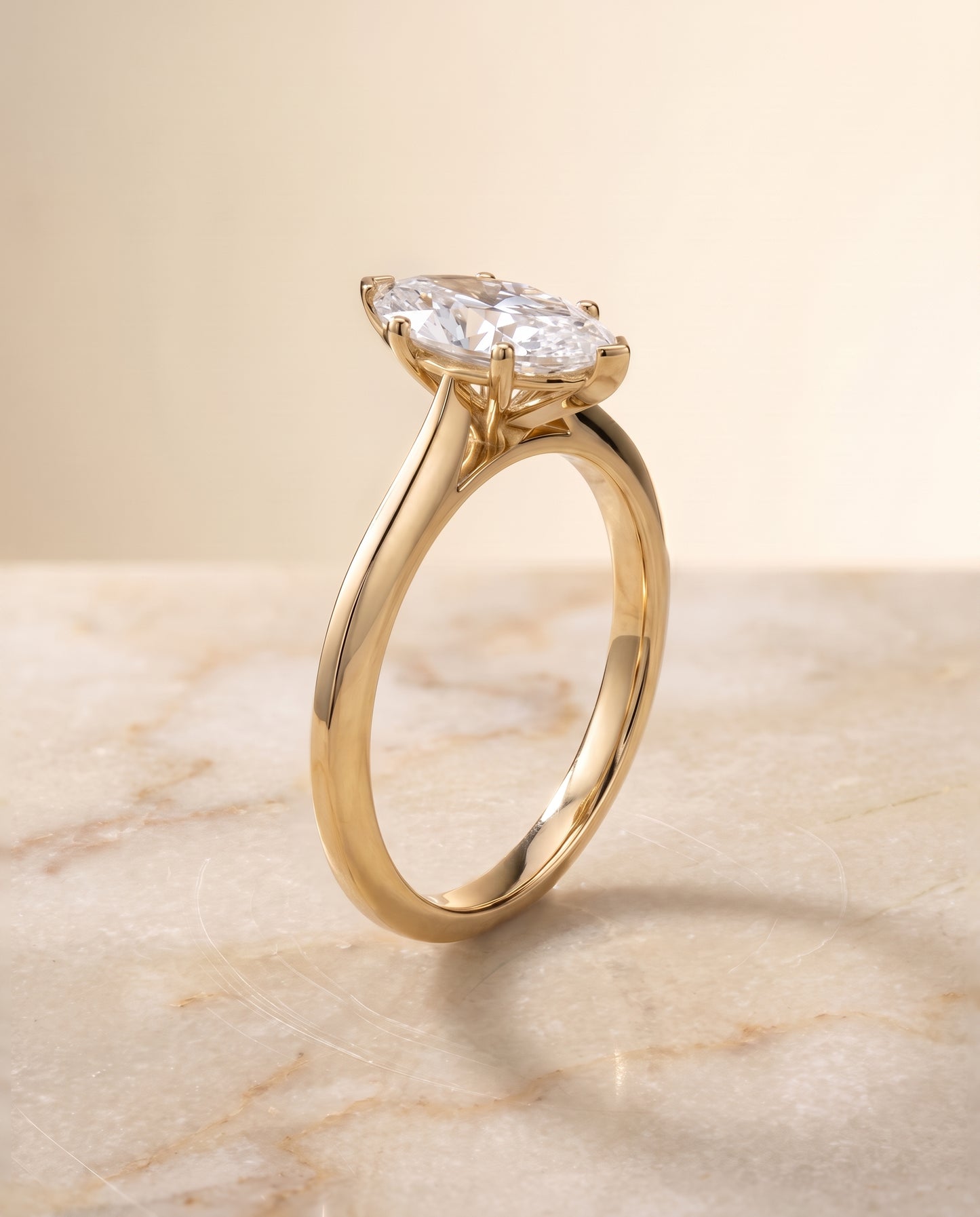 The Elena Timeless Graduated Beveled Shank Solitaire Marquise Engagement Ring Setting in 18K Yellow Gold