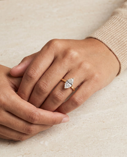 The Elena Timeless Graduated Beveled Shank Solitaire Marquise Engagement Ring Setting in 18K Yellow Gold
