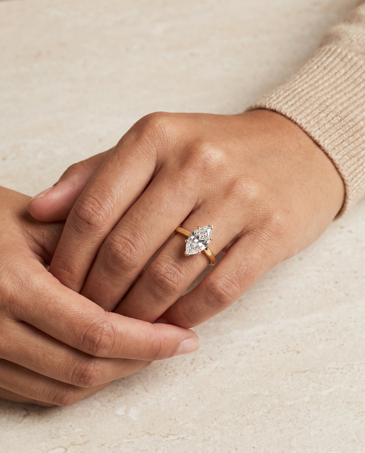 The Elena Timeless Graduated Beveled Shank Solitaire Marquise Engagement Ring Setting in 18K Yellow Gold
