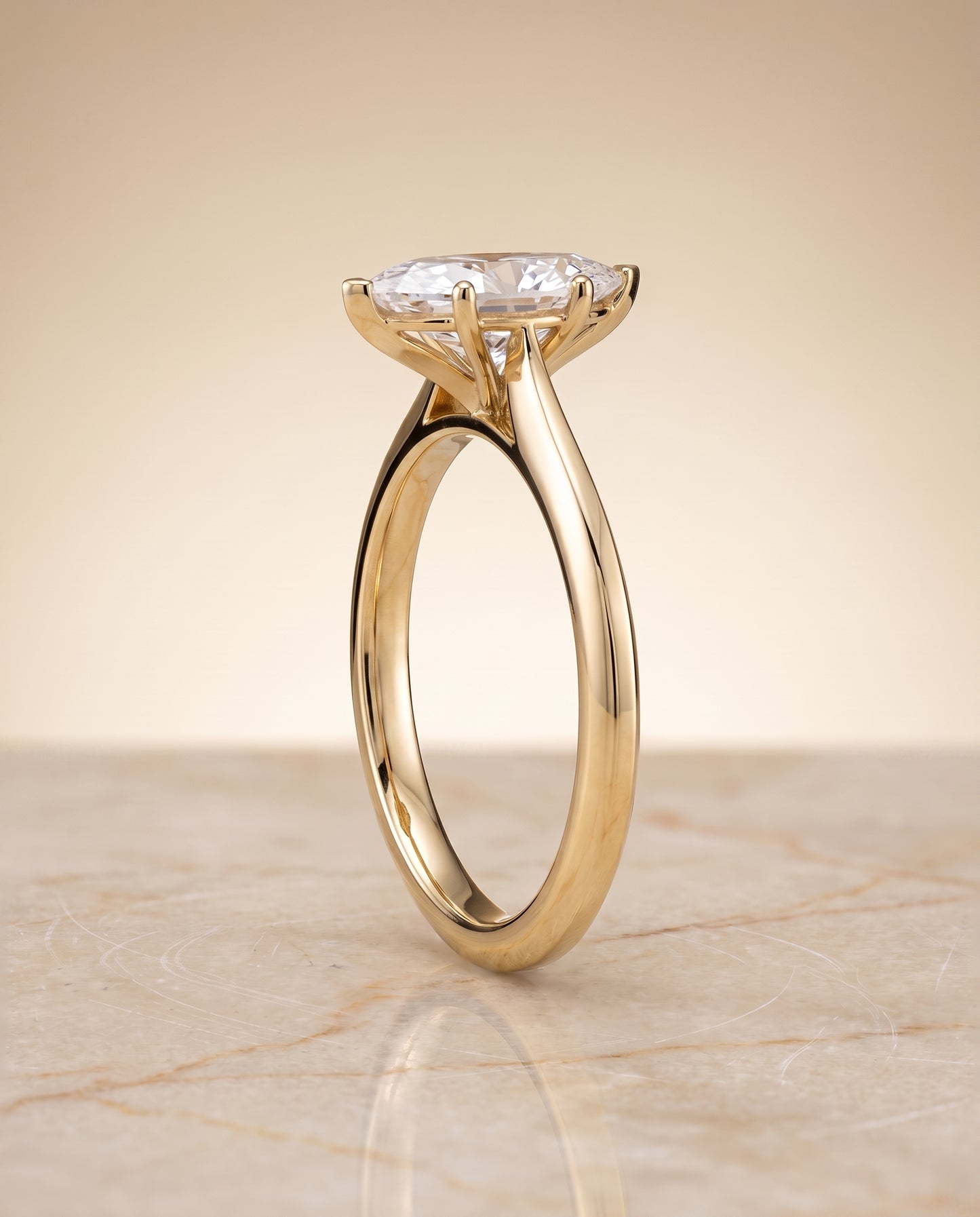 The Elena Timeless Graduated Beveled Shank Solitaire Marquise Engagement Ring Setting in 18K Yellow Gold