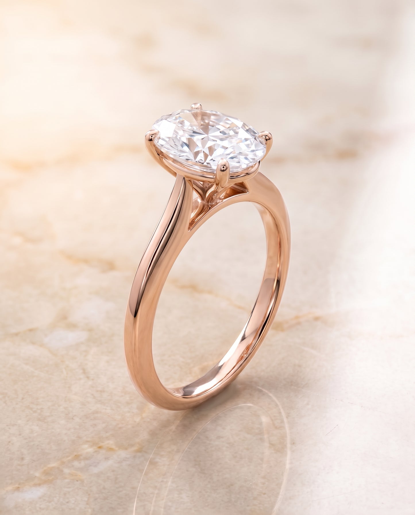 The Elena Timeless Graduated Beveled Shank Solitaire Oval Engagement Ring Setting in 14K Rose Gold