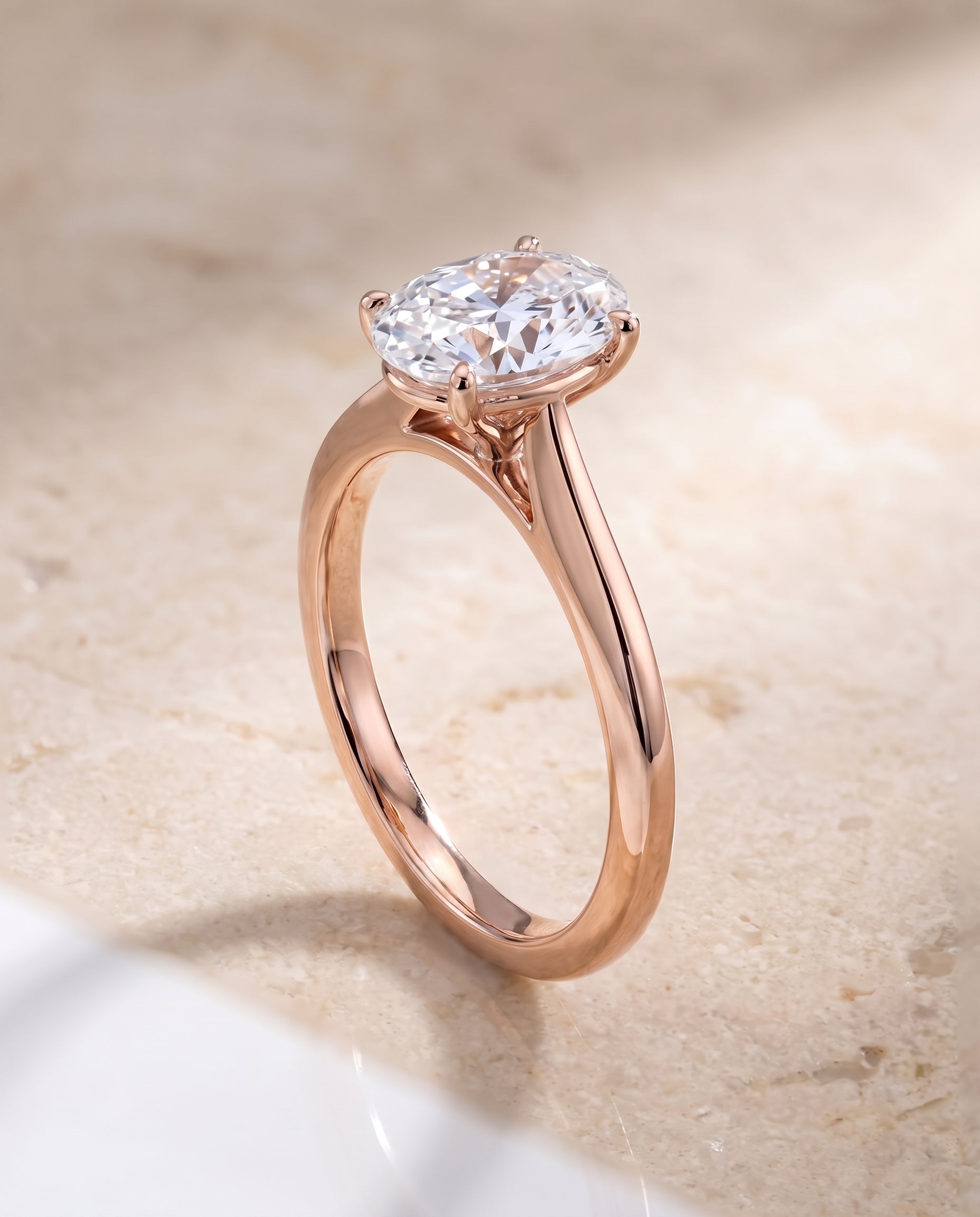 The Elena Timeless Graduated Beveled Shank Solitaire Oval Engagement Ring Setting in 14K Rose Gold
