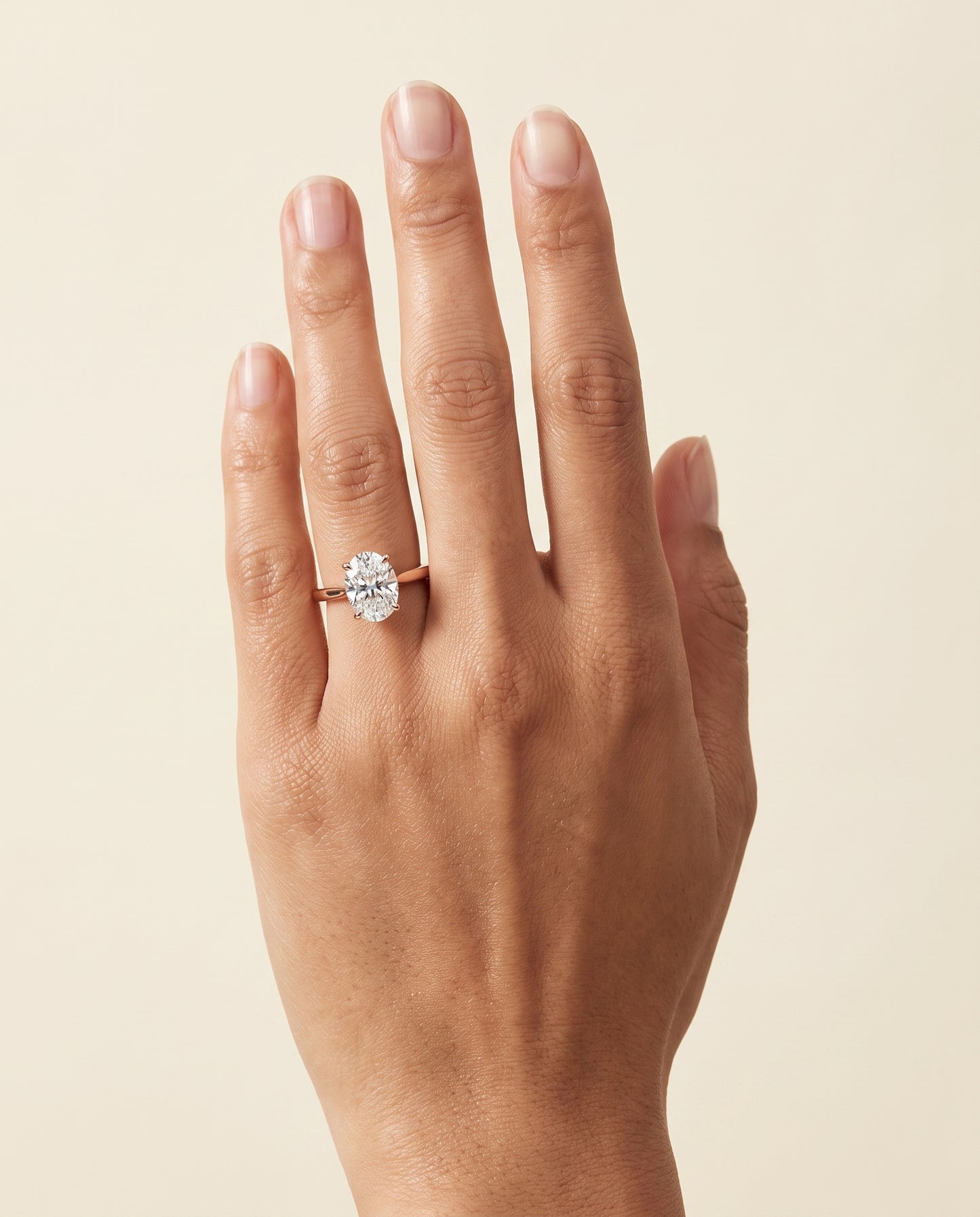 The Elena Timeless Graduated Beveled Shank Solitaire Oval Engagement Ring Setting in 14K Rose Gold