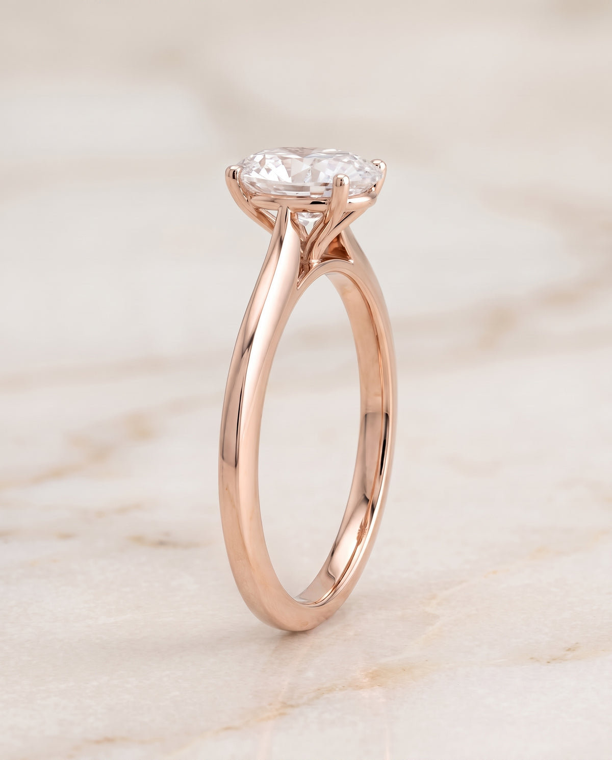 The Elena Timeless Graduated Beveled Shank Solitaire Oval Engagement Ring Setting in 14K Rose Gold