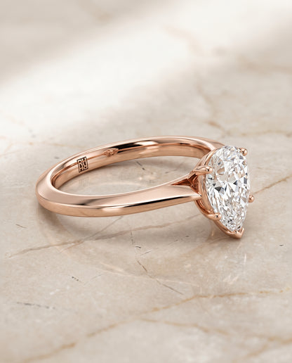 The Elena Timeless Graduated Beveled Shank Solitaire Pear Engagement Ring Setting in 14K Rose Gold