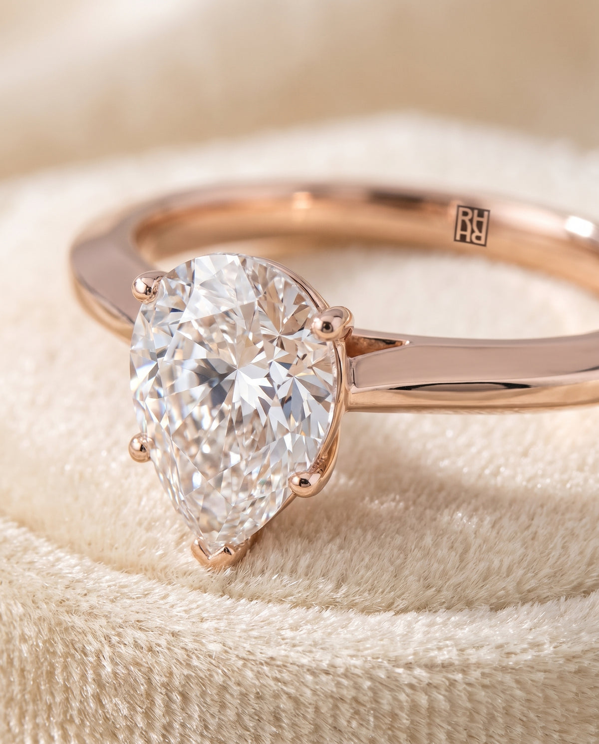 The Elena Timeless Graduated Beveled Shank Solitaire Pear Engagement Ring Setting in 14K Rose Gold