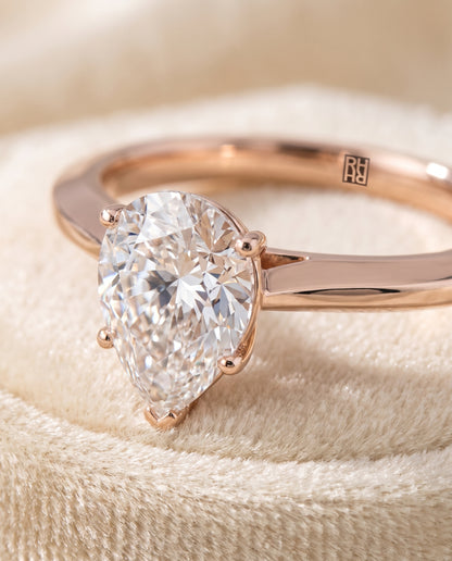 The Elena Timeless Graduated Beveled Shank Solitaire Pear Engagement Ring Setting in 14K Rose Gold