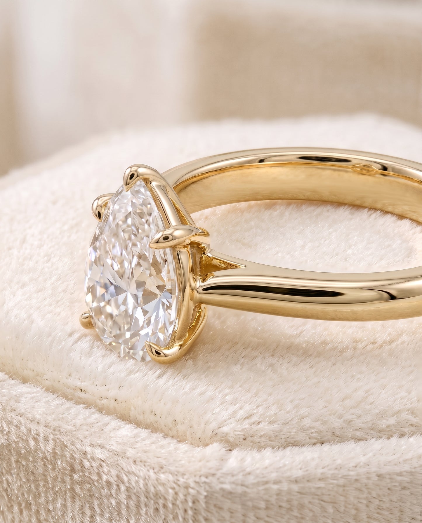 The Elena Timeless Graduated Beveled Shank Solitaire Pear Engagement Ring Setting in 18K Yellow Gold