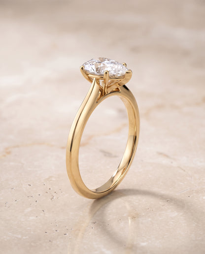 The Elena Timeless Graduated Beveled Shank Solitaire Pear Engagement Ring Setting in 18K Yellow Gold