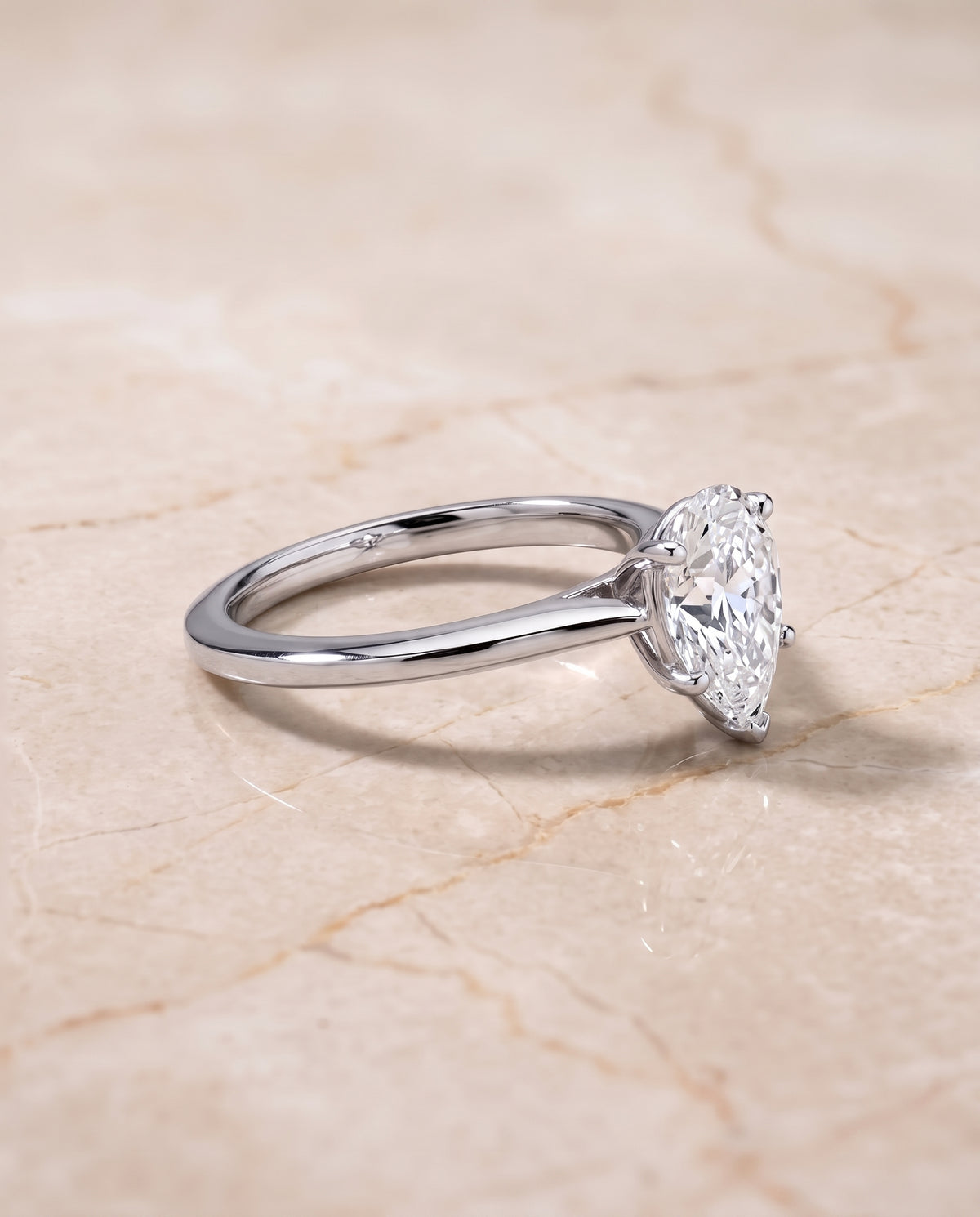 The Elena Timeless Graduated Beveled Shank Solitaire Pear Engagement Ring Setting in Platinum