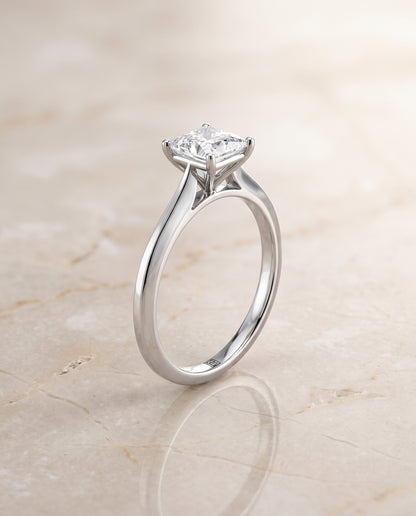 The Elena Timeless Graduated Beveled Shank Solitaire Princess Cut Engagement Ring Setting in Platinum