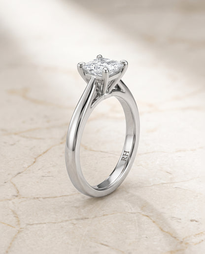 The Elena Timeless Graduated Beveled Shank Solitaire Princess Cut Engagement Ring Setting in Platinum
