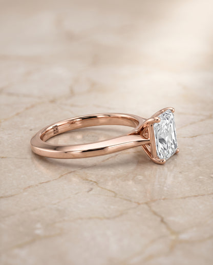 The Elena Timeless Graduated Beveled Shank Solitaire Radiant Cut Engagement Ring Setting in 14K Rose Gold