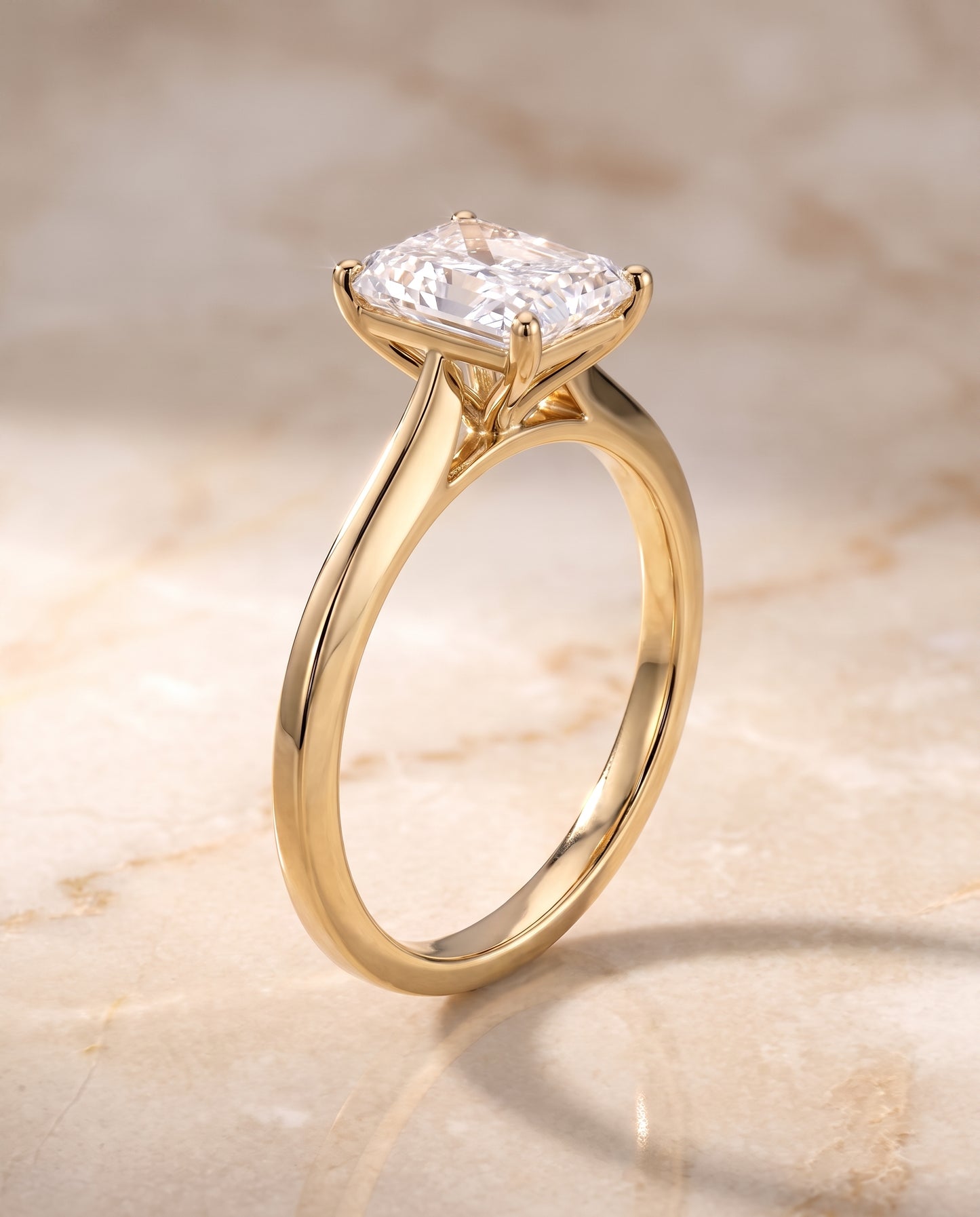 The Elena Timeless Graduated Beveled Shank Solitaire Radiant Cut Engagement Ring Setting in 18K Yellow Gold
