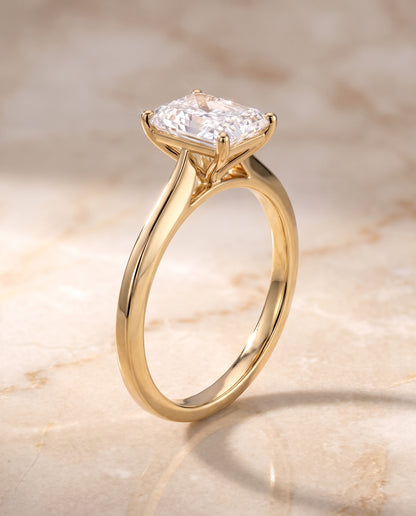 The Elena Timeless Graduated Beveled Shank Solitaire Radiant Cut Engagement Ring Setting in 18K Yellow Gold