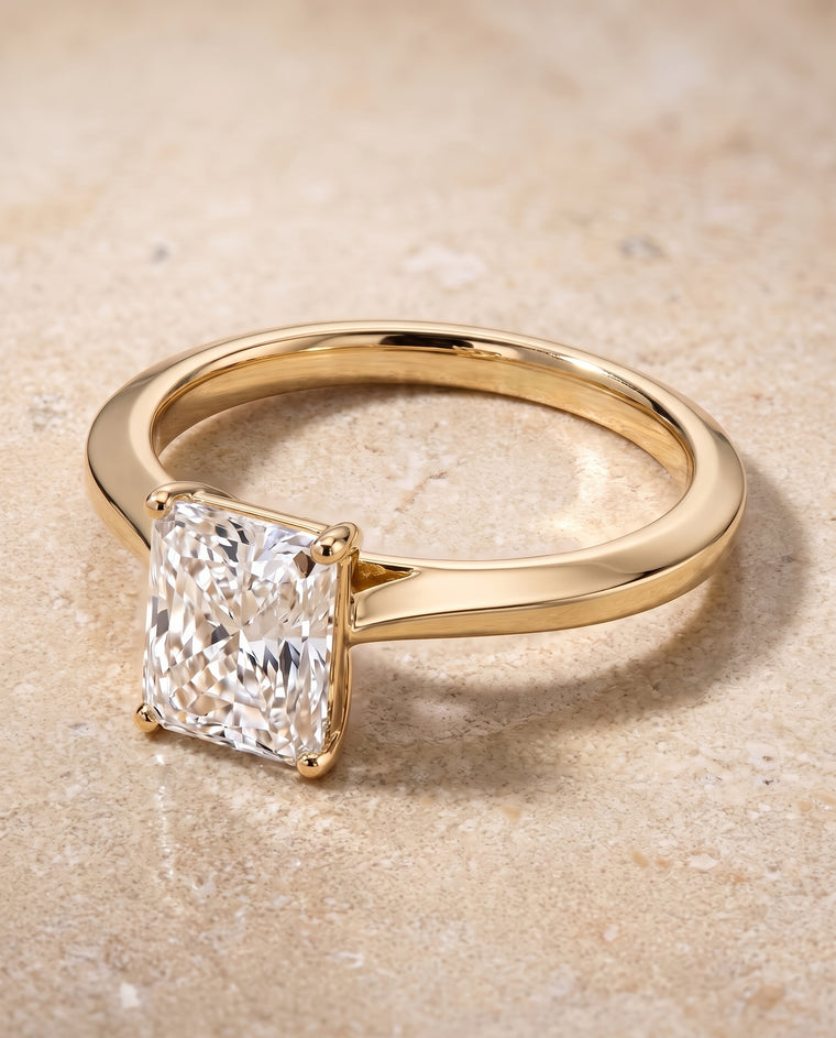 The Elena Timeless Graduated Beveled Shank Solitaire Radiant Cut Engagement Ring Setting in 18K Yellow Gold
