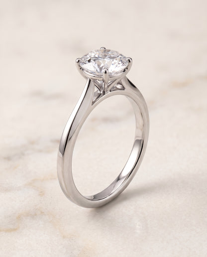 The Elena Timeless Graduated Beveled Shank Solitaire Round Engagement Ring Setting in 18K White Gold