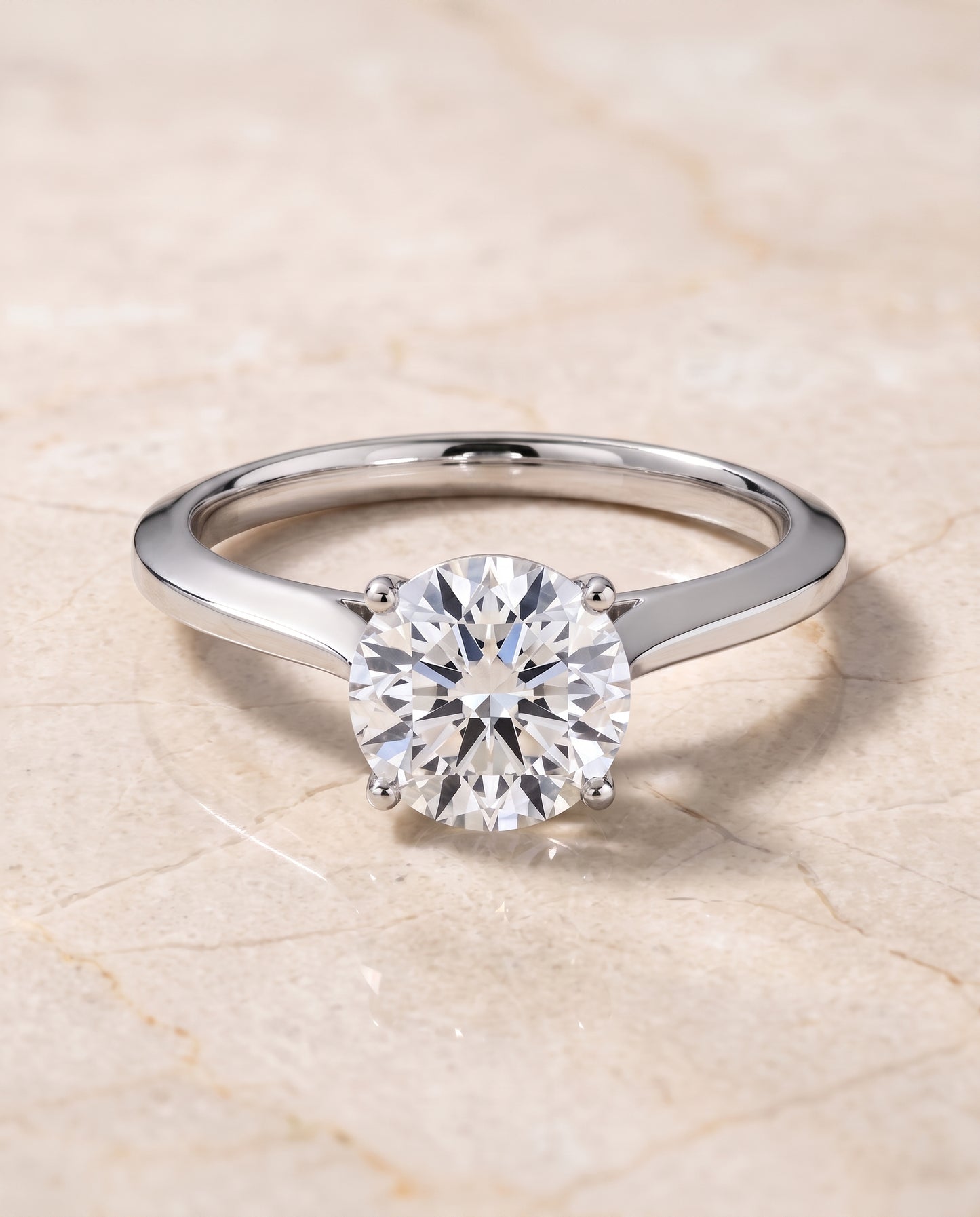 The Elena Timeless Graduated Beveled Shank Solitaire Round Engagement Ring Setting in 18K White Gold