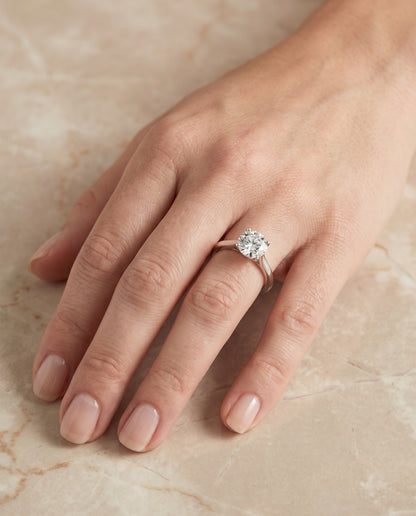 The Elena Timeless Graduated Beveled Shank Solitaire Round Engagement Ring Setting in 18K White Gold