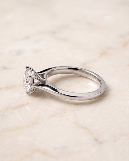 The Elena Timeless Graduated Beveled Shank Solitaire Round Engagement Ring Setting in 18K White Gold