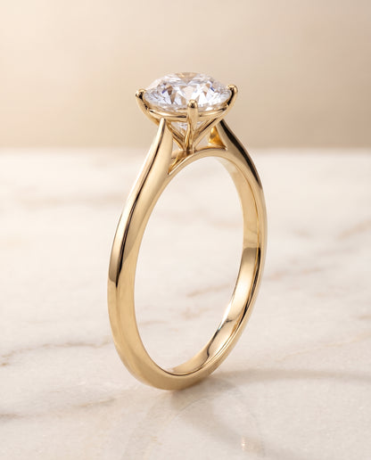 The Elena Timeless Graduated Beveled Shank Solitaire Round Engagement Ring Setting in 18K Yellow Gold