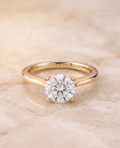 The Elena Timeless Graduated Beveled Shank Solitaire Round Engagement Ring Setting in 18K Yellow Gold
