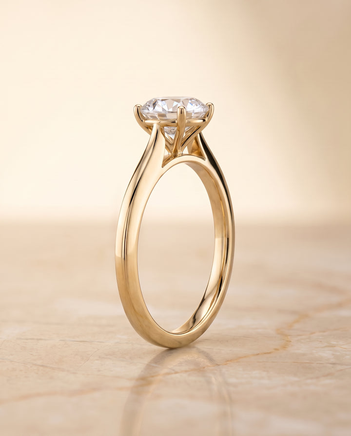 The Elena Timeless Graduated Beveled Shank Solitaire Round Engagement Ring Setting in 18K Yellow Gold