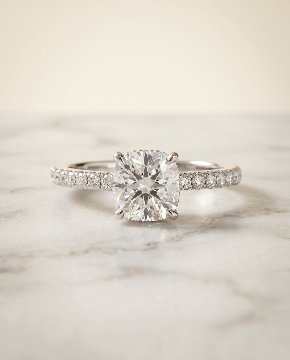 Elliott Select Hidden Halo Pavé Cushion Cut Lab Diamond Engagement Ring in Platinum, shown on hand, angled | RockHer