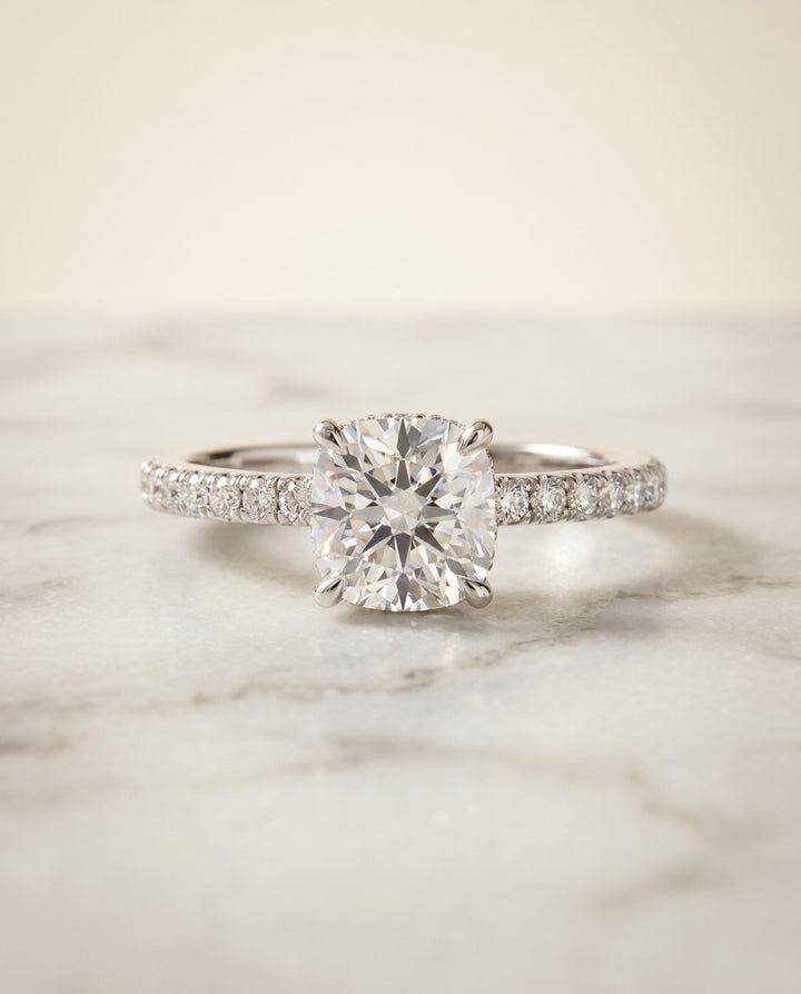 Elliott Select Hidden Halo Pavé Cushion Cut Lab Diamond Engagement Ring in Platinum, shown on hand, angled | RockHer