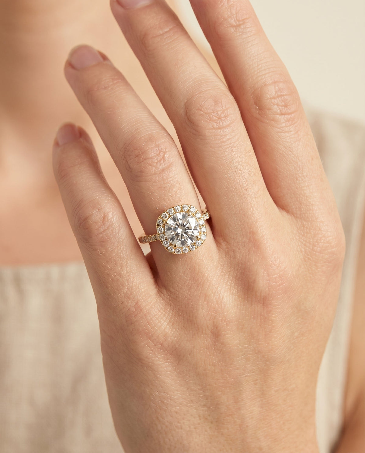 Everly Select Halo Round Lab Diamond Engagement Ring in 18K Yellow Gold, shown on hand | RockHer