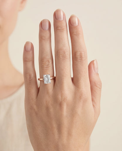 The Floria Comfort Fit Claw Prong Solitaire Emerald Cut Engagement Ring Setting in 14K Rose Gold